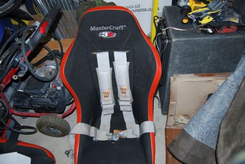 1982 Ford Bronco - A racing seat with a MasterCraft logo and a 5-point harness is shown in a cluttered area.