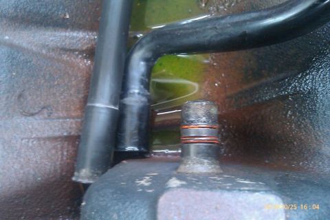 2000 Mercury Grand Marquis - Close-up of an engine component with green fluid and hoses visible.