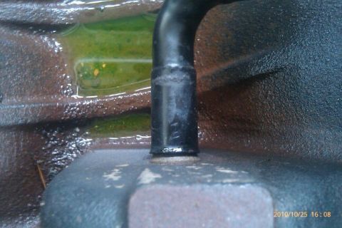 2000 Mercury Grand Marquis - Coolant leak visible around a pipe fitting on an engine component.