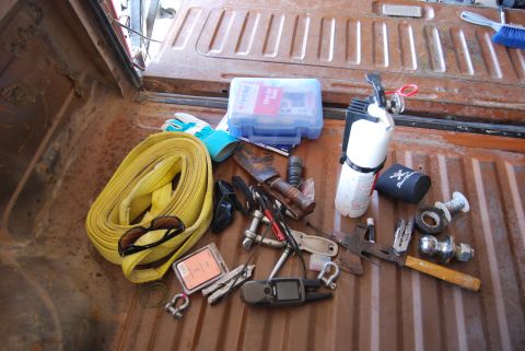 1982 Ford Bronco - Various tools and equipment are organized in the bed of a truck.