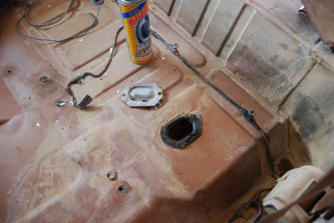1982 Ford Bronco - The interior floor pan of a vehicle, showing wiring and a can of AutoZone brake cleaner.