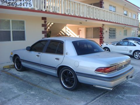 1994 Mercury Grand Marquis - Rear view of a silver 1994 Mercury Grand Marquis sedan parked outside.