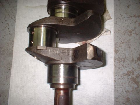 1964 Ford Galaxie - Close-up of a crankshaft, showing the casting mark C4AE-B. This part is not a 1964 Ford Galaxie.
