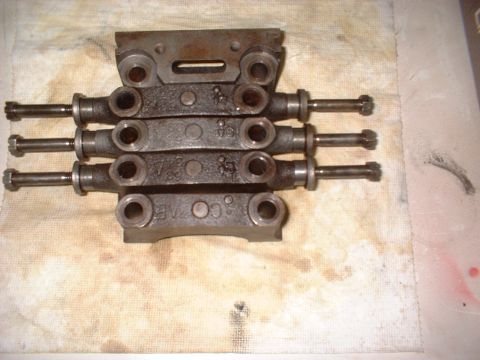 1964 Ford Galaxie - Close-up of a disassembled engine component, showing rocker arms and bolts on a stained cloth.