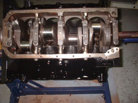 1964 Ford Galaxie - Close-up view of an engine block assembly, showing the crankshaft and connecting rods. The Supermotors.net logo is visible in the lower rig…