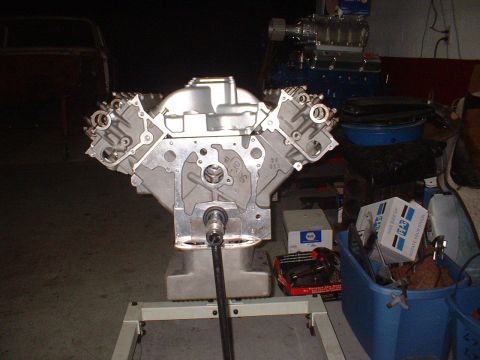 1965 Shelby Cobra - Engine block on a stand, with a supercharger in the background. No year is visible.