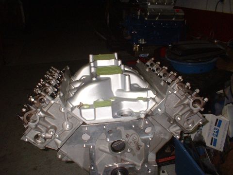 1965 Shelby Cobra - A V8 engine block with intake manifold and valve covers is shown, possibly a 427 SOHC engine.