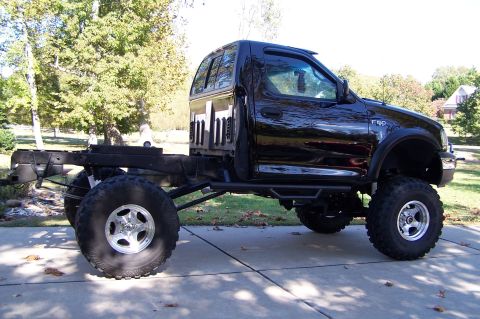 2000 Ford F-150 - This modified Ford F-150 has been stripped of its bed and lifted with oversized tires.