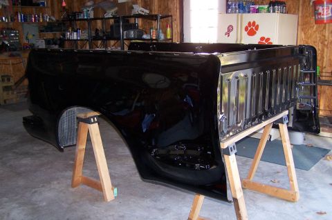 2000 Ford F-150 - A black truck bed is supported by sawhorses in a garage setting.