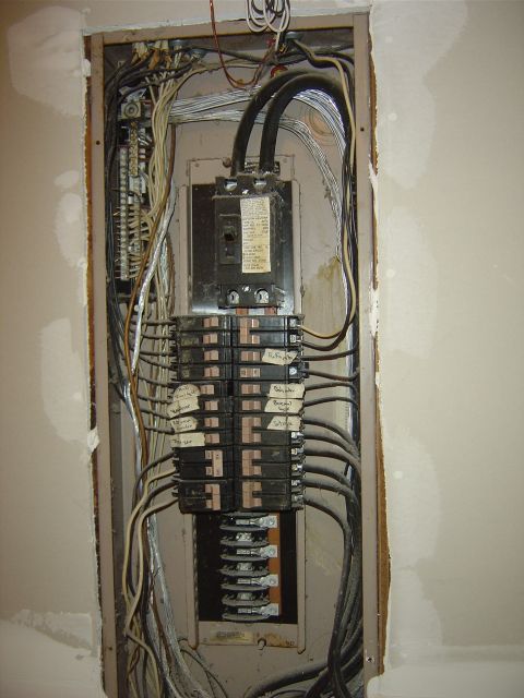 1986 Ford Bronco - This is an electrical breaker panel with numerous wires and circuit breakers, some of which are labeled.