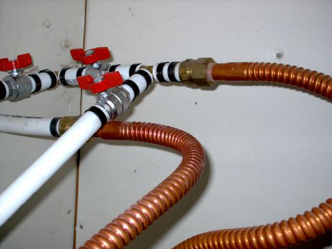 1965 Ford Mustang - Close-up view of plumbing pipes and valves, with a watermark for Supermotors.net visible.