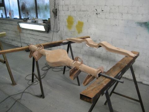 1973 Ford Ranchero - Automotive rear axle and frame components are disassembled and supported on sawhorses in a workshop setting.