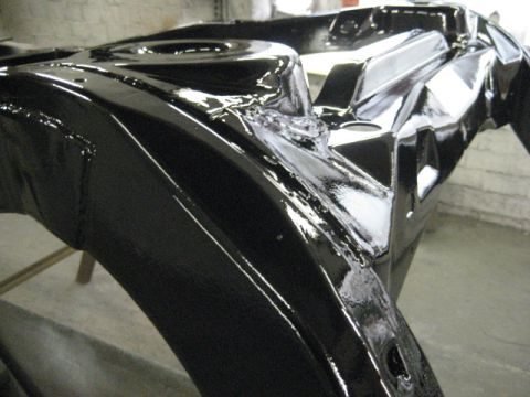1973 Ford Ranchero - Close-up of a freshly painted vehicle frame section during a rebuild.