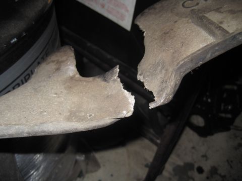 1979 Ford Bronco - This is a broken metal part, possibly from a vehicle, shown in two pieces.