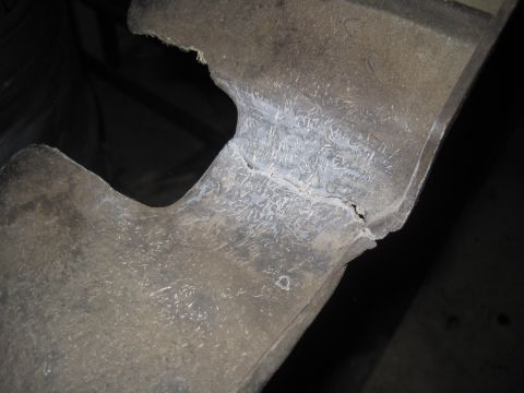 1979 Ford Bronco - This close-up shows a damaged section of a gray metal part, revealing cracks and numerous fine scratches.