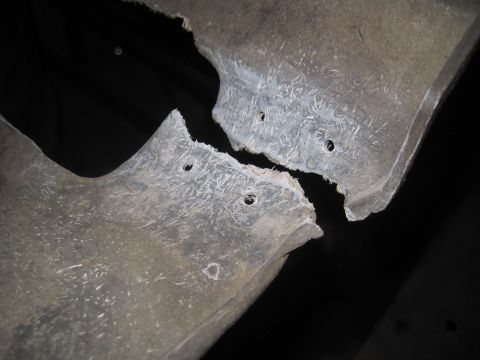 1979 Ford Bronco - Close-up of a damaged fiberglass component, showing its internal structure and mounting points.