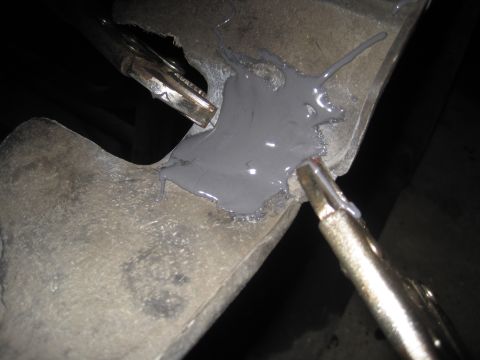 1979 Ford Bronco - Automotive part repair using putty and clamps.