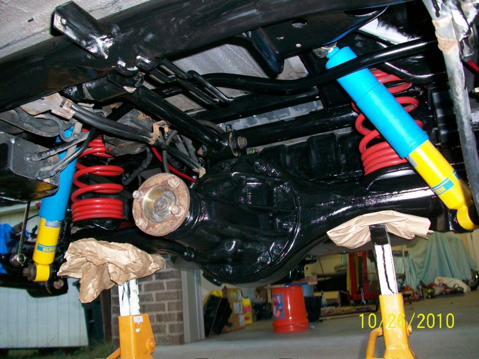 Rear axle with red springs and blue Bilstein shocks