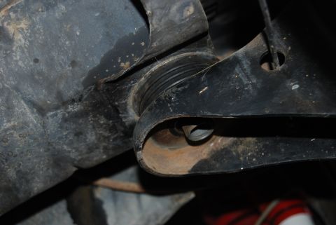 1982 Ford Bronco - A close-up view of a vehicle's undercarriage shows a suspension component with a rubber boot and bolt, but no clear year identification.