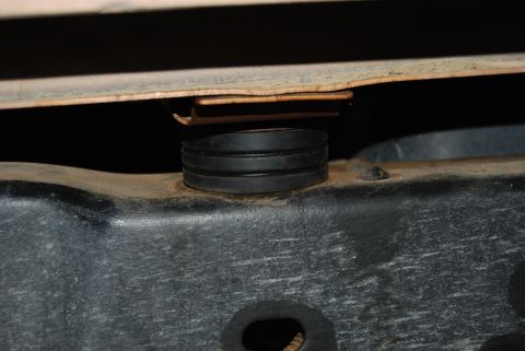 1982 Ford Bronco - Close-up view of a rubber body mount on a vehicle frame.