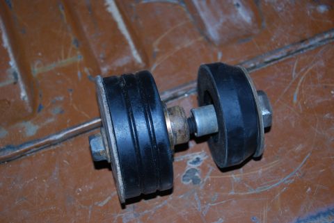 1982 Ford Bronco - A close-up view of a rubber and metal component with visible bolts and washers.