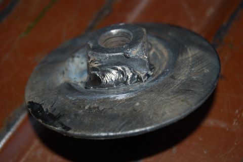 1982 Ford Bronco - This is a close-up view of a metal component that has been welded to a nut, showing signs of use.