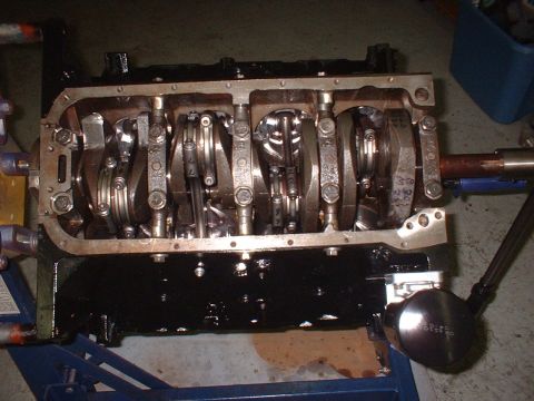 1964 Ford Galaxie - Close-up view of an engine block's internal components, including the crankshaft and connecting rods, with the oil pan removed.