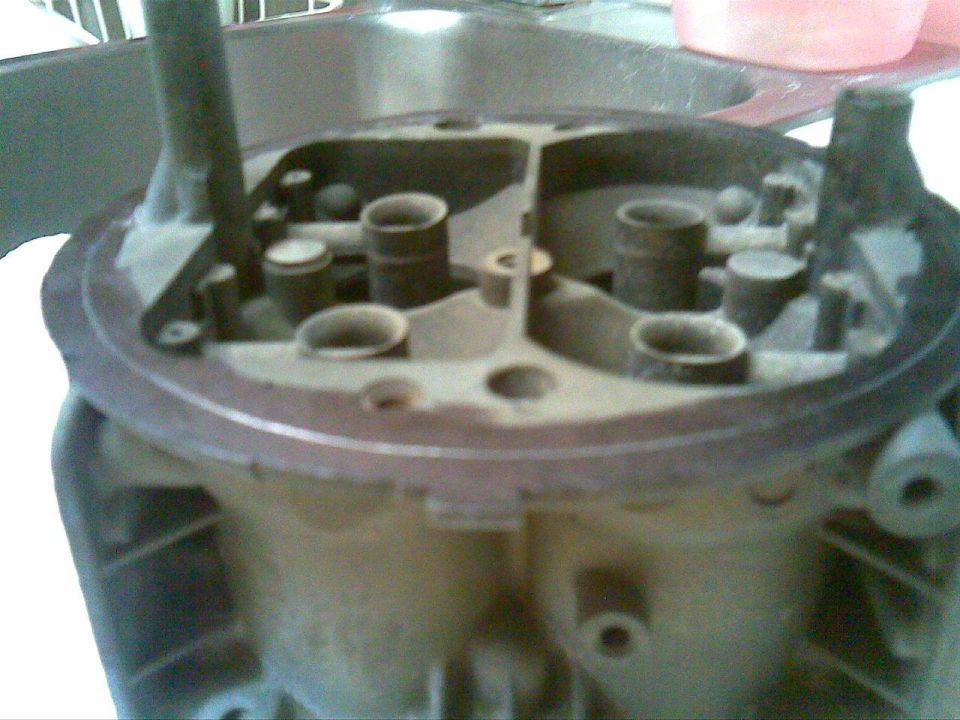 Carburetor top view, showing four intake ports and internal mechanisms