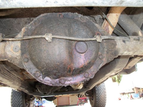1992 Jeep Cherokee - The underside of a vehicle reveals a heavily corroded rear differential assembly.