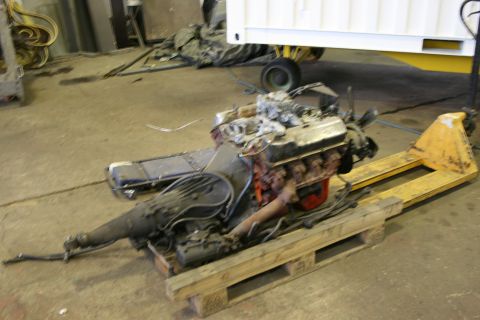 1973 Ford Ranchero - Engine and transmission assembly resting on a wooden pallet and yellow pallet jack.