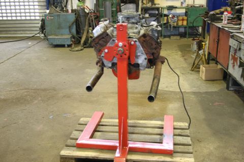 1973 Ford Ranchero - Engine assembly mounted on a red stand in a garage or workshop setting.