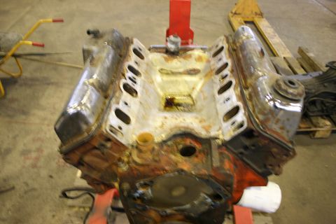 1973 Ford Ranchero - V8 engine block, likely needing rebuild, sits on an engine stand.