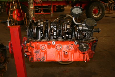 1973 Ford Ranchero - Ford V8 engine block and crankshaft assembly on an engine stand in a workshop.