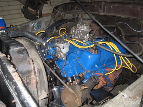 1979 Ford Bronco - Close-up of a blue V8 engine, showing the carburetor and spark plug wires.