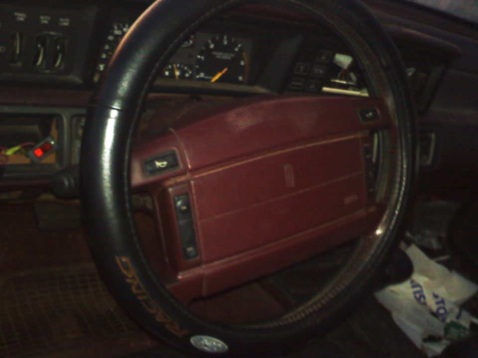 Red dashboard and steering wheel interior of a car