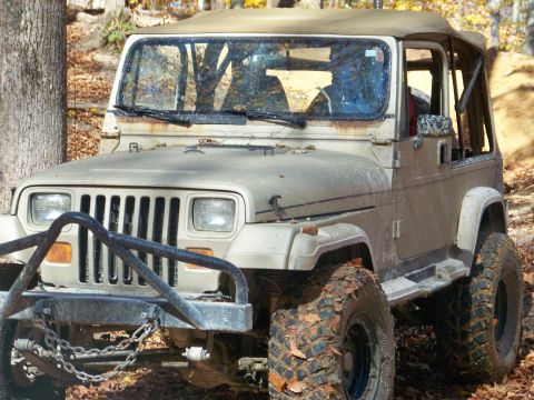 1987 Ford F-250 - This Jeep Wrangler is equipped with off-road tires and a brush guard, ready for rough terrain.