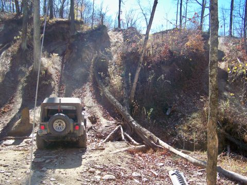 1987 Ford F-250 - Off-roading scene with a Jeep Wrangler navigating a challenging dirt path.