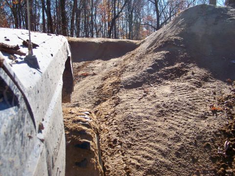 1987 Ford F-250 - A vehicle navigates a challenging dirt terrain with a steep embankment.