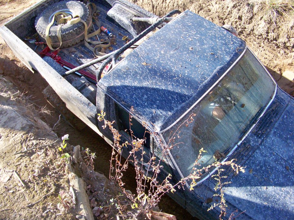 Dark blue 1987 Ford F-250 stuck in mud, seen from above