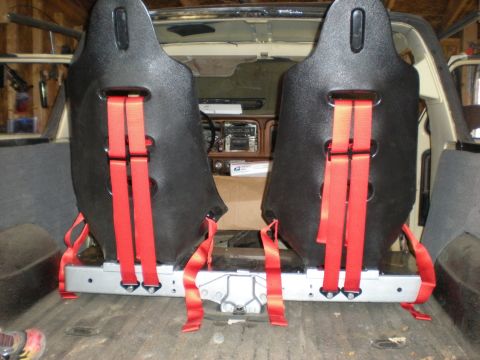 1978 Ford Bronco - The interior of a 1978 Ford Bronco shows two black racing seats with red harnesses installed.