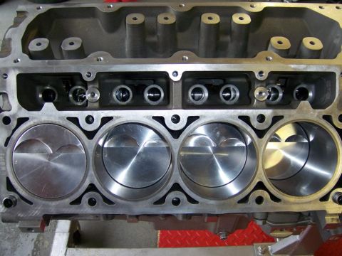 2006 Chevrolet Corvette - Close-up view of an engine block's cylinder bores and pistons, with valve train components visible at the top.