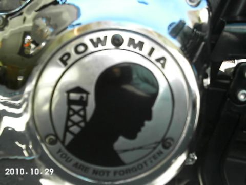 1996 Harley-Davidson Super Glide - Close-up of a motorcycle part a POW MIA emblem with the inscription 'YOU ARE NOT FORGOTTEN'.