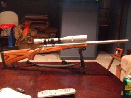 1996 Ford Bronco - A rifle with a scope is displayed on a table, with household items in the background.