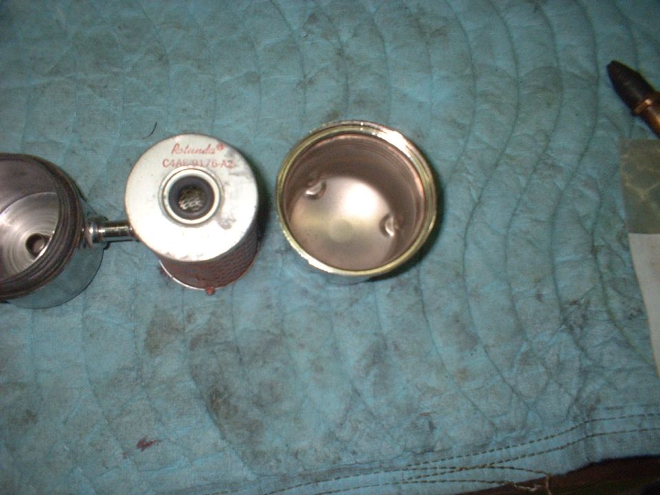 Rotunda oil filter with part number C4AB-6170-A2 next to its housing