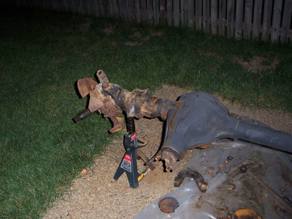 Front axle assembly on jack stands, rusty