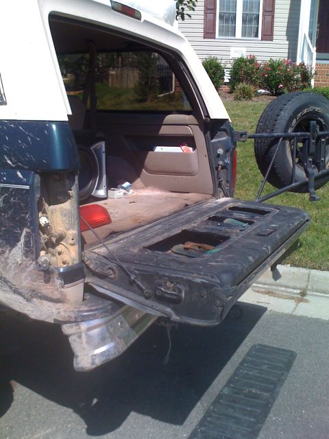 1992 Ford Bronco - Rear view of a 1992 Ford Bronco showing the open tailgate and interior cargo area.