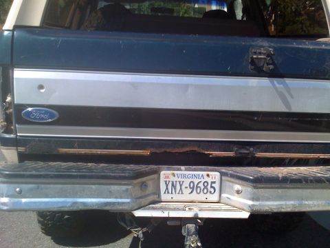 1992 Ford Bronco - The rear of a 1992 Ford Bronco shows a Virginia license plate and some rust on the bumper.