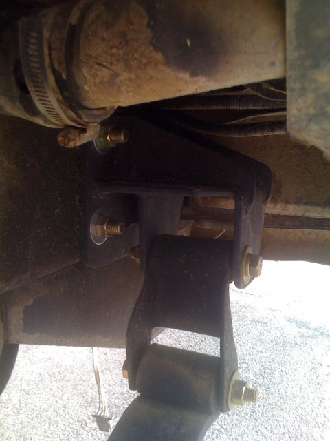 1992 Ford Bronco - This image shows a close-up view of a vehicle's suspension system, focusing on a specific component and its mounting hardware.