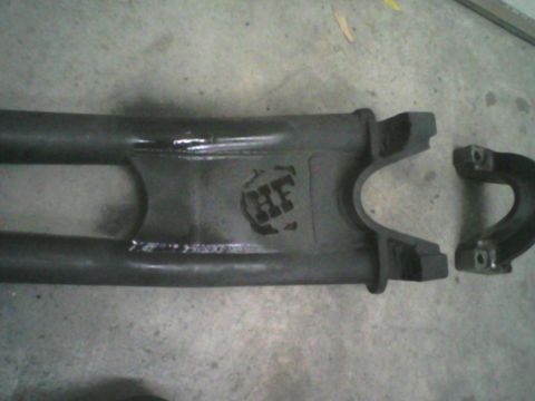 1993 Ford Bronco - A close-up view of a vehicle driveshaft component with a visible manufacturer's mark.