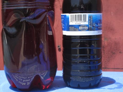 1995 Ford Bronco - Two bottles containing dark fluid are shown side-by-side, with one bottle a product label.